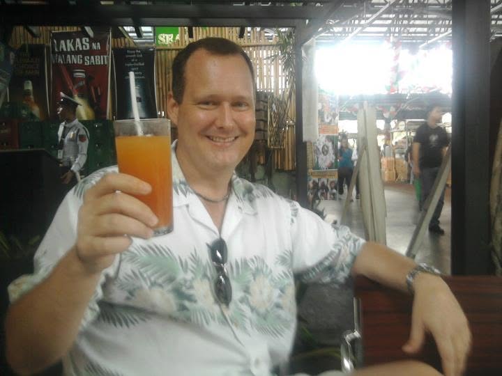 Steve and Cirila smiling close together in a selfie at Market Market at Serendra.