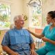 A 68-year-old man sitting in a dental chair with a Filipino dental hygienist seated beside him during a dental visit in the Philippines