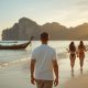 Solo traveler walking along a beach in the Philippines at sunset.