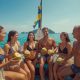 Group of travelers laughing together on a boat in a turquoise lagoon in the Philippines on a sunny day.