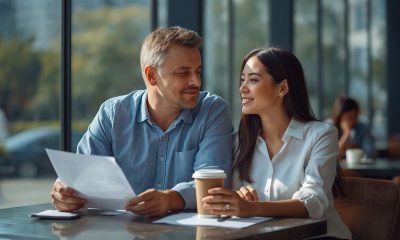 AI-generated image of a smiling man and woman at a café table, looking at each other while he holds a document and she holds a coffee cup